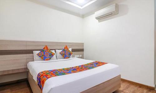 a bedroom with a large bed in a room at FabHotel Pride Inn Financia in Hyderabad