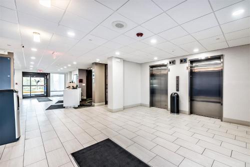an office with a lobby with two elevators in it at Holiday Inn Express Flint-Campus Area by IHG in Flint