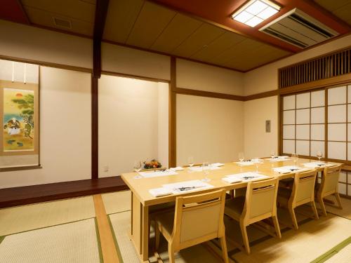 a large room with a long table and chairs at Hotel Flags Kuju Kusima in Sasebo