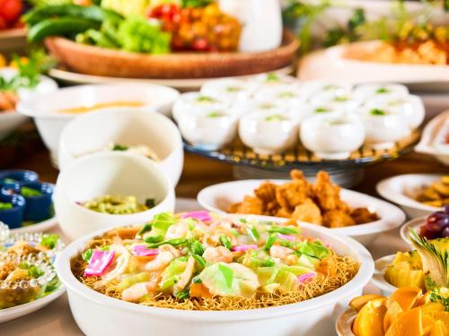 a table full of plates of food on a table at Hotel Flags Kuju Kusima in Sasebo
