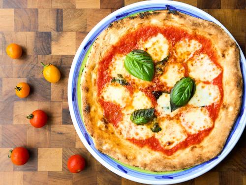 a pizza sitting on top of a table at Hotel Flags Kuju Kusima in Sasebo