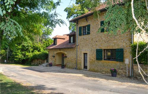 a stone house with a driveway in front of it at Gorgeous Apartment In Vitrac With Wifi in Vitrac