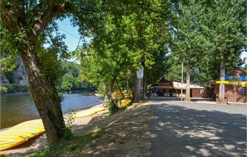 a row of large yellow boats on a river at Gorgeous Apartment In Vitrac With Wifi in Vitrac