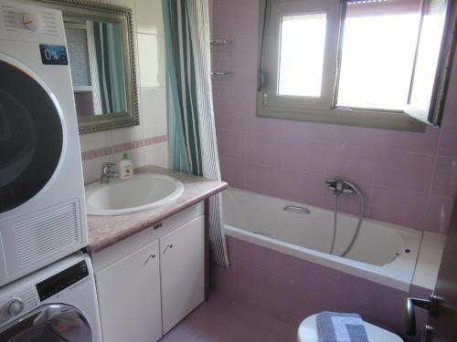 La salle de bains est pourvue d'un lavabo et d'une baignoire. dans l'établissement Seaside Boutique Villa, à Vólos