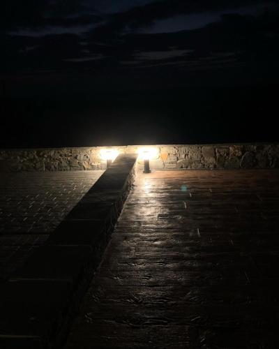 a row of lights on a stone wall at night at Killard House in Caherlean
