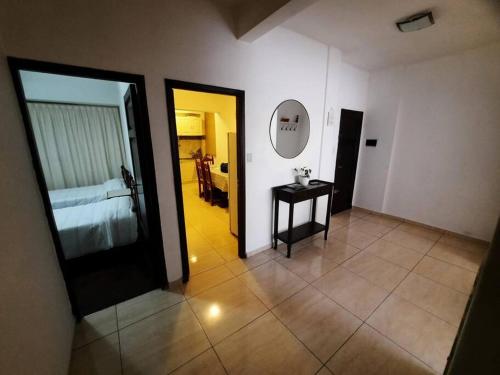 a hallway with a bed and a table in a room at Hermoso Departamento centrico in Cordoba