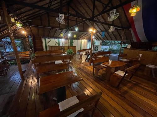 an overhead view of a restaurant with wooden tables and benches at Vanara Bungalows in Ko Chang