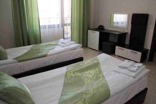 a hotel room with two beds and a mirror at Incanto Family Hotel in Sevlievo
