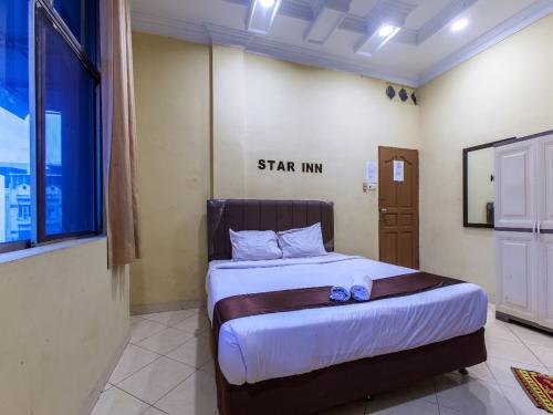 a bedroom with a bed in a room at Star Inn Medan in Medan