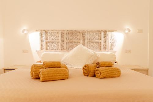 a white bed with two stuffed teddy bears on it at House On The Sea Porto Rotondo in Porto Rotondo