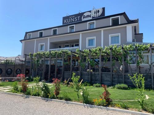 a building with a garden in front of it at Hotel Kunst in Krško