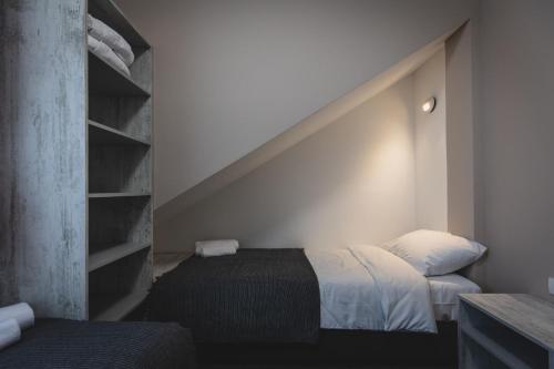 a bedroom with two beds and a book shelf at Navigator in Palić