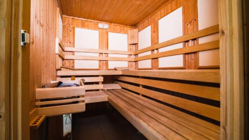 an empty sauna with wooden walls and windows at Alpe Adria Apartments - Top 1 by S4Y in Faak am See