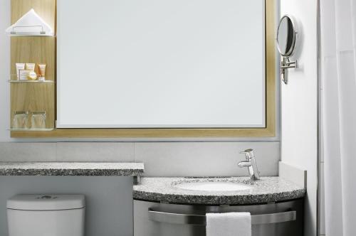 a bathroom with a sink and a mirror at Club Quarters Hotel World Trade Center, New York in New York