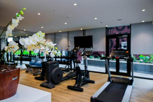 a gym with treadmills and exercise bikes in a room at Crowne Plaza - Dar Es Salaam by IHG in Dar es Salaam