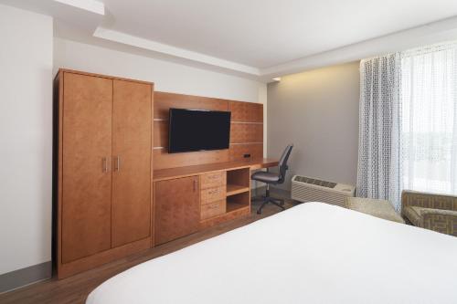 a hotel room with a bed and a flat screen tv at DoubleTree by Hilton Miami North I-95 in Miami
