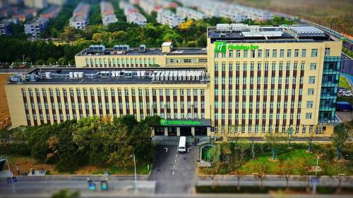 a large yellow building with a train on top of it at Holiday Inn Shanghai Dishui Lake by IHG in Nanhui