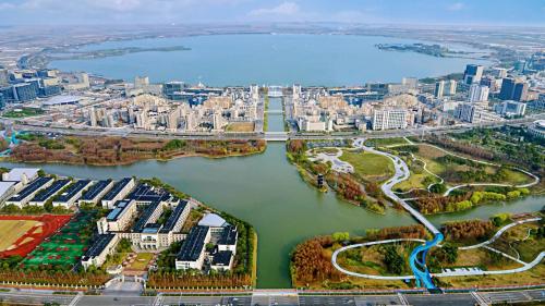 an aerial view of a river and a city at Holiday Inn Shanghai Dishui Lake by IHG in Nanhui
