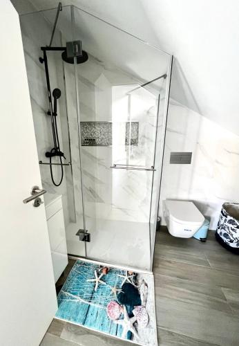 a shower with a glass door in a bathroom at LUXURY PENTHOUSE - River Gallery Art - View&Center in Vila Nova de Gaia
