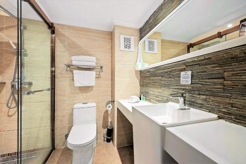 a bathroom with a toilet and a sink and a shower at Eltham Gateway Hotel & Conference Centre in Eltham