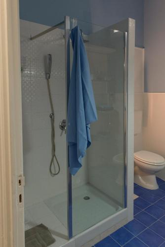 a shower with a glass door in a bathroom at Opera Prima 28 in Palermo