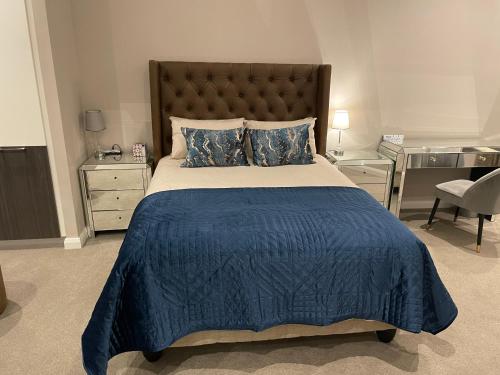 a bedroom with a large bed with a blue blanket at Stazamaine 1421 in Pretoria