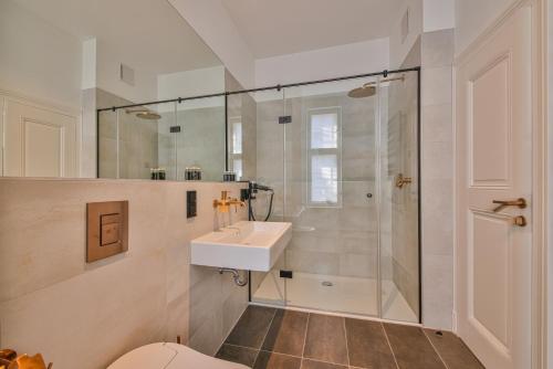 a bathroom with a sink and a shower at Aeronaut Suits by Pearl1 in Berlin