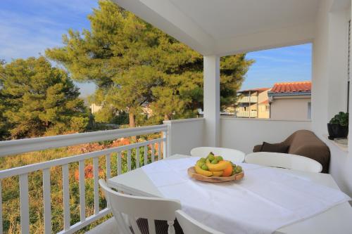 a bowl of fruit on a table on a balcony at Apartments by the sea Rogoznica - 4162 in Rogoznica