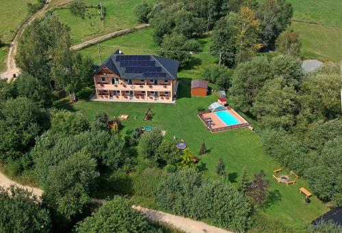 an aerial view of a large house with a swimming pool at Apartmány Nad rybníky in Horní Planá