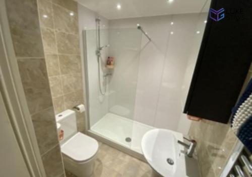 a bathroom with a shower and a toilet and a sink at Luke Stays - Clayton Street in Newcastle upon Tyne