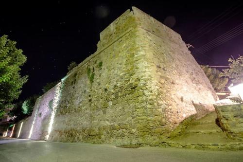 a large stone wall at night at Heart of Kissamos Apartment in Kissamos