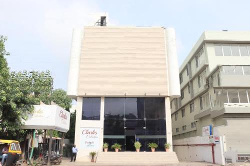 a building with a man standing in front of it at Hotel Clarks Collection Bhavnagar in Bhavnagar
