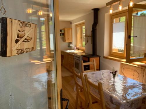a kitchen and dining room with a table and a counter top at Chalet Baita delle Favole di RosaRita in Berbenno di Valtellina