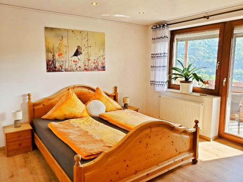 a bedroom with a wooden bed and a window at Ferienwohnung Sonnenblick in Edersee