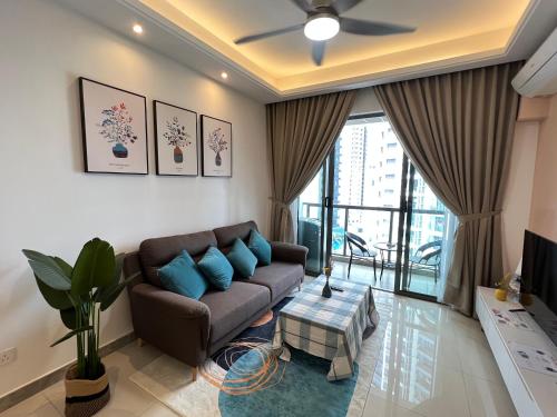 a living room with a couch and a ceiling fan at R&F PRINCESS COVE at ANJU in Johor Bahru
