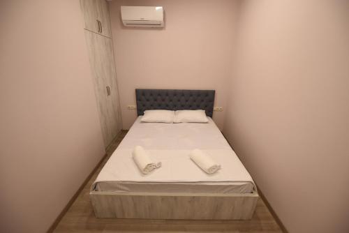 a small bedroom with a bed with two towels on it at Family Hotel Avlabar in Tbilisi City