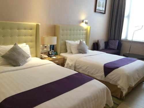 Krevet ili kreveti u jedinici u objektu Shenzhen The Bauhinia Hotel, Mix City Shopping Center