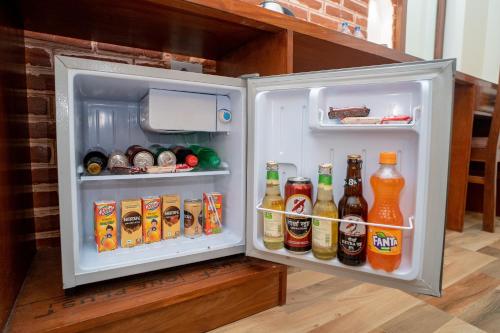 an open refrigerator filled with lots of drinks at Madhuban Hotel in Kathmandu