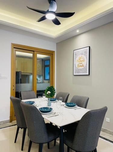 a dining room with a table with chairs and a ceiling fan at R&F PRINCESS COVE at ANJU in Johor Bahru
