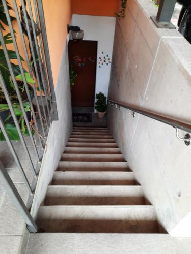 a stairway leading up to a door at #10ilnumeroperfetto, independent entrance, private parking & garten in Morbio Inferiore