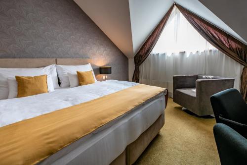 Postel nebo postele na pokoji v ubytování Hotel Větruše