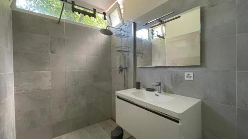a bathroom with a sink and a mirror at La casa sul lago in Maroggia