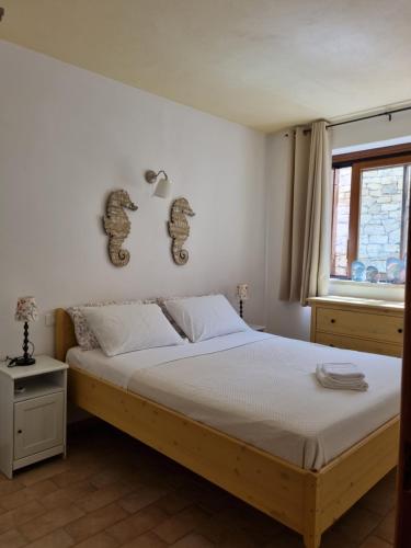 a bedroom with a bed and a window at Paxos villas in Gaios