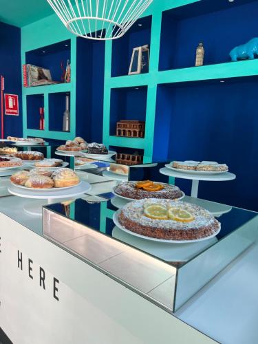 a buffet with many different types of cakes on display at Hotel Spicy in Sorrento