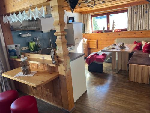 a kitchen and living room in a log cabin at Berghof am Schwand in Hinterhornbach