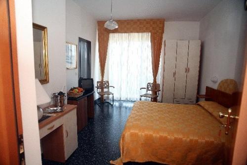 a hotel room with a bed and a window at Hotel Rosa Meublé in Porto San Giorgio