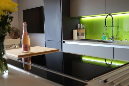 a kitchen with a sink and a bottle on a table at Apartment Seven in Shrewsbury