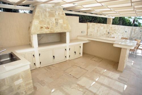 a kitchen with a sink and a counter top at Seafront 5 Bedroom Villa Paradise in Sea Caves in Peyia