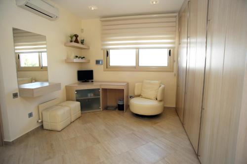 a room with a desk and a chair and a computer at Seafront 5 Bedroom Villa Paradise in Sea Caves in Peyia