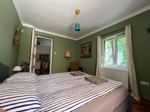 a bedroom with a bed and a window at Hangvilla vendégház in Miskolc